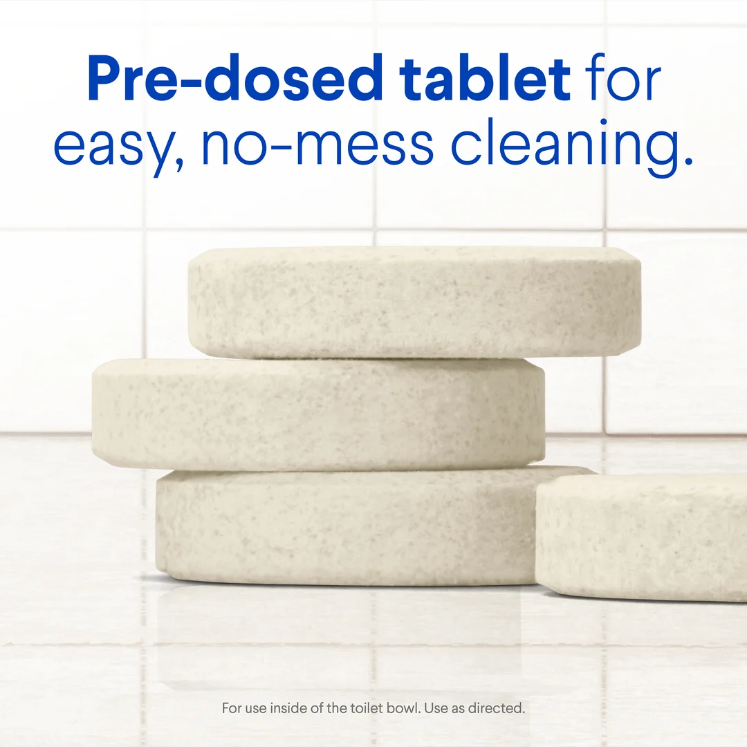 Lavender clean tablets on a tile surface with the words "Pre-dosed tablet for easy, no-mess cleaning"