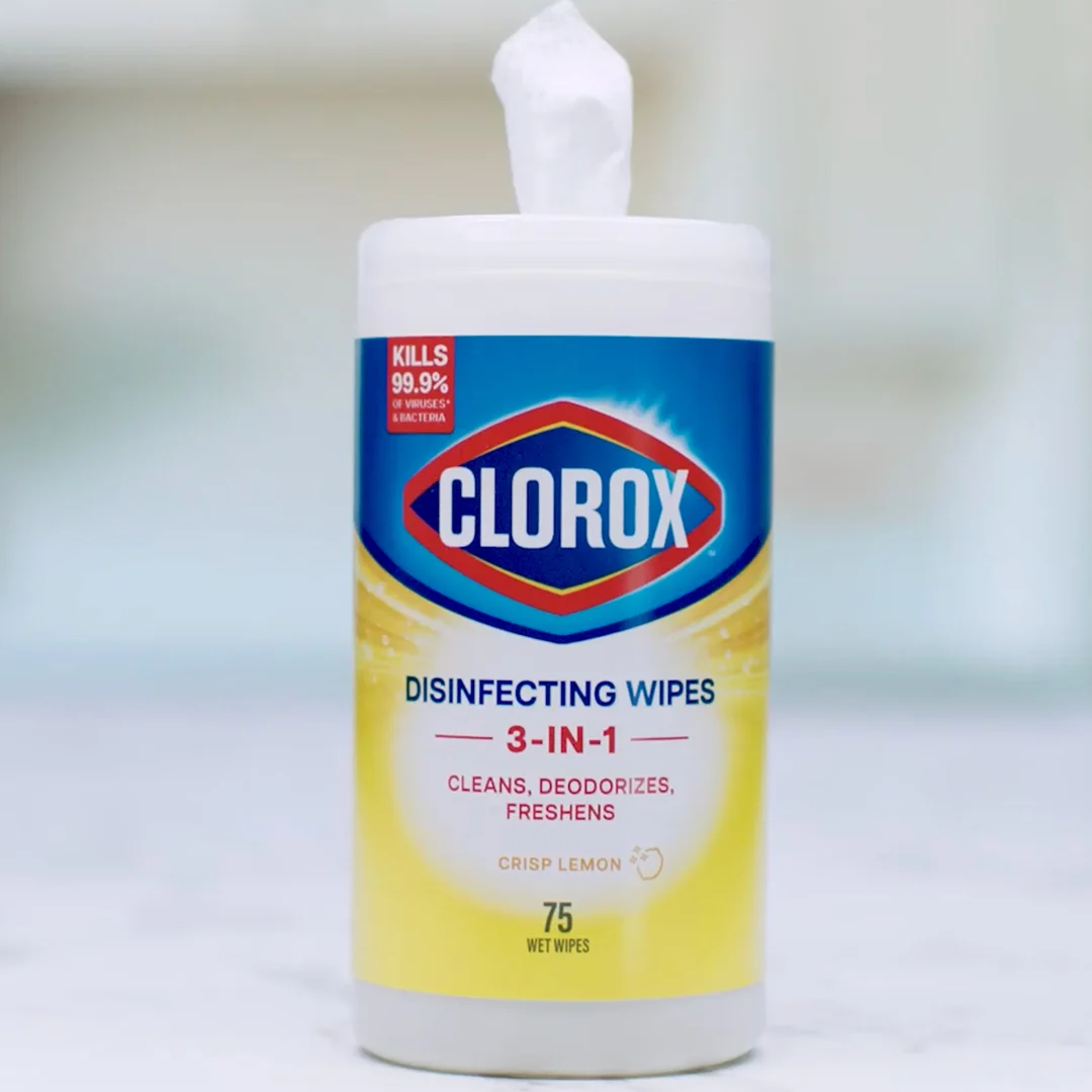 A canister of lemon scented Clorox Disinfecting Wipes on a counter with a blurred background