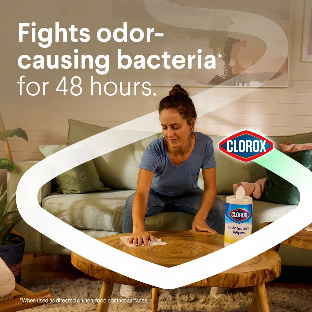 Fights odor-causing bacteria for 48 hours: Woman cleaning a coffee table with disinfecting wipes