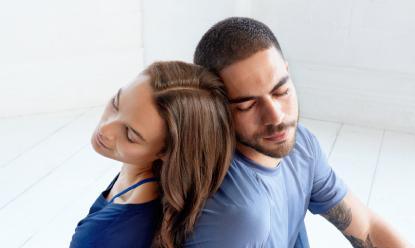 couple with closed eyes leaning their heads against each other