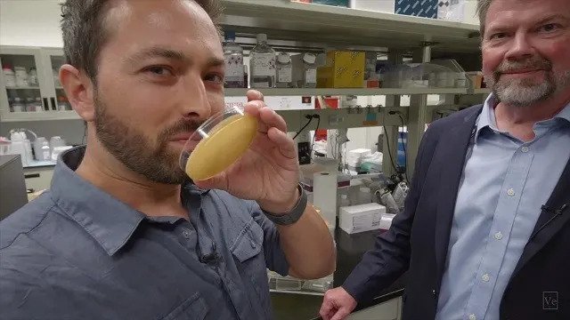 Science vlogger smelling some medical samples in the lab
