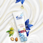 Suprême Colour Protect Conditioner, surrounded by olives and argan seeds 
