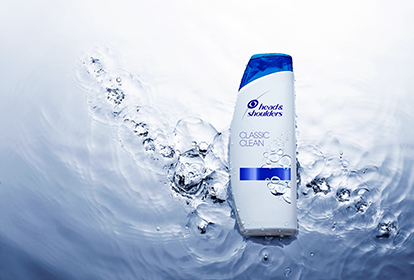 Head&Shoulders Classic Clean Shampoo Bottle lying on the water surface.