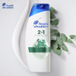 Head&Shoulders Itchy Scalp Shampoo bottle with twigs and creamy streak in the background 