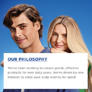 A blonde woman is resting her hands on a young man's back.