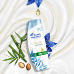 Suprême Strength Shampoo, surrounded by bamboo and argan seeds