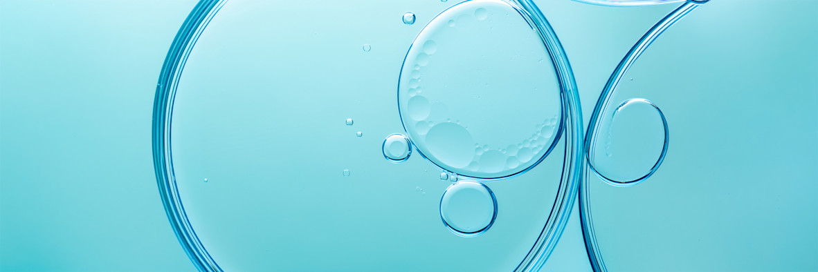 Abstract teal background with translucent spherical bubbles suggesting active ingredients.