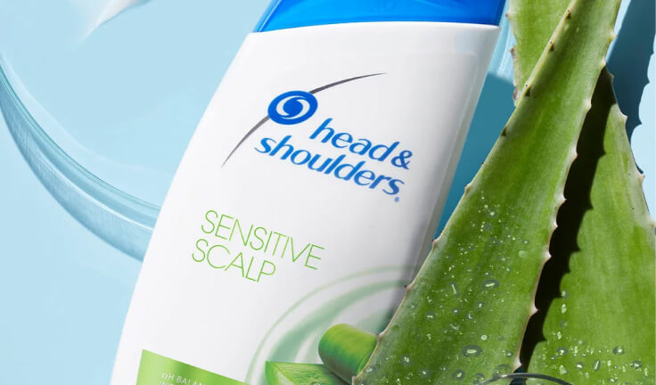 Head&Shoulders Sensitive Scalp shampoo bottle with aloe leaves on the side, zoomed.