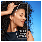 Smiling woman with curly hair, advertising Head & Shoulders is suitable for all scalp types.