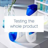 Head&Shoulders shampoo bottles in the laboratory environment and the text 'Testing the whole product' on white square.