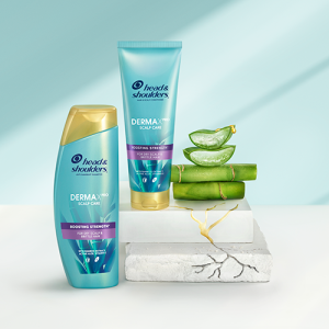 The Boosting Strength Collection products standing on crannied surfaces next to slices of cut aloe and a pieces of bamboo