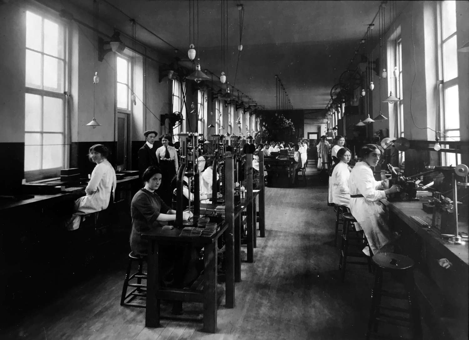 Monotype employees operating the punchcutting and matrix-making machines, early twentieth century. © Monotype archives