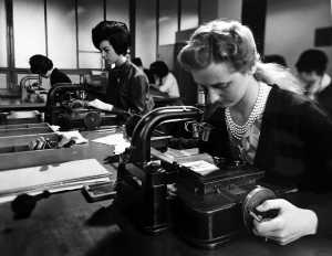 Employees of the Monotype matrix factory checking the quality of the copper patterns used for producing metal punches. Undated photograph. Courtesy Richard Cooper