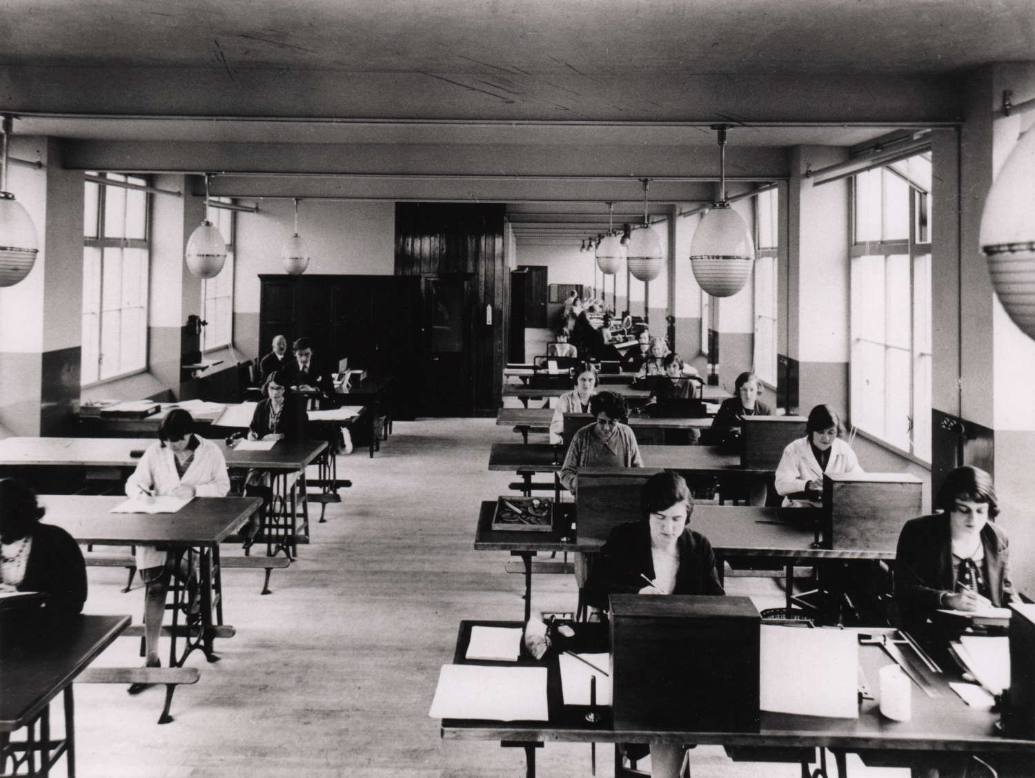 View of the Monotype TDO, c. 1928. Dora Laing sits in the front row in the middle, wearing a black cardigan. She would have been in her early twenties. Courtesy St Bride Library