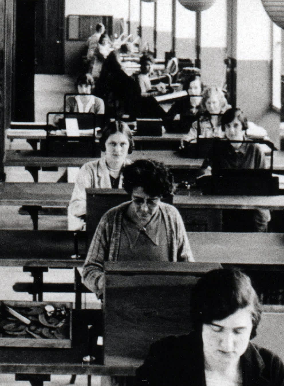 Dora Pritchett is most likely the woman with glasses, sitting here at her desk in the second row. Closeup of a view of the Monotype TDO, c. 1928. © Monotype archives