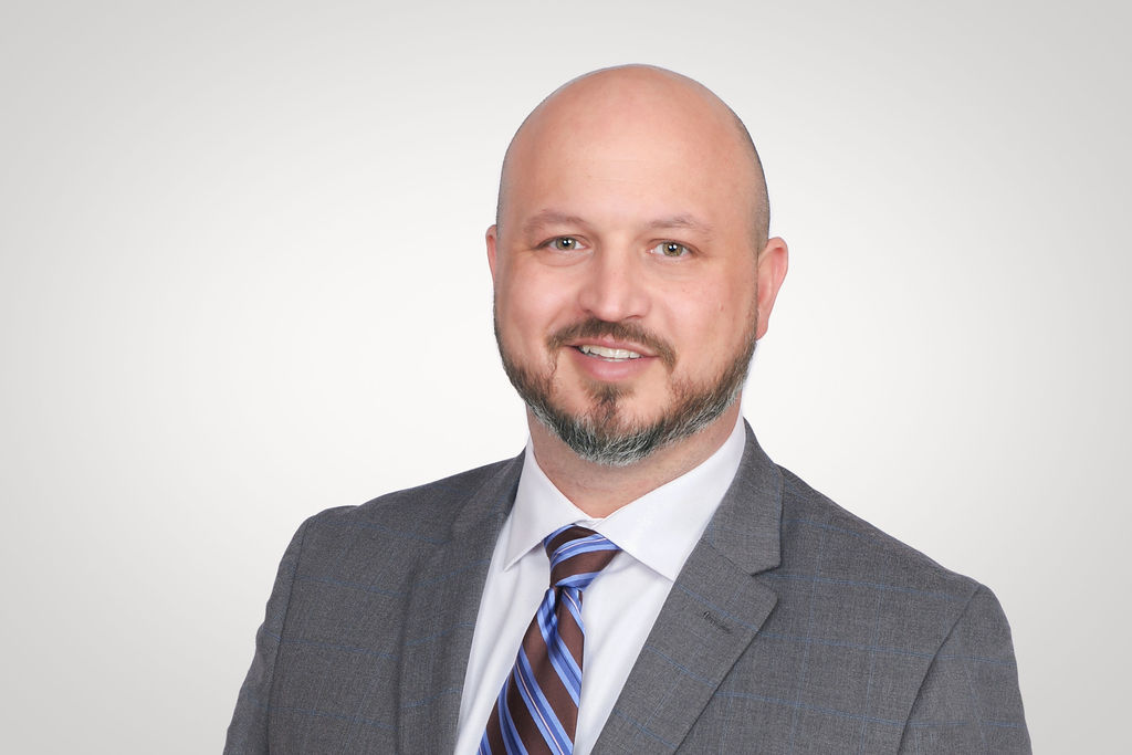 Airport Dimensions, businessman headshot, grey suit jacket with tie