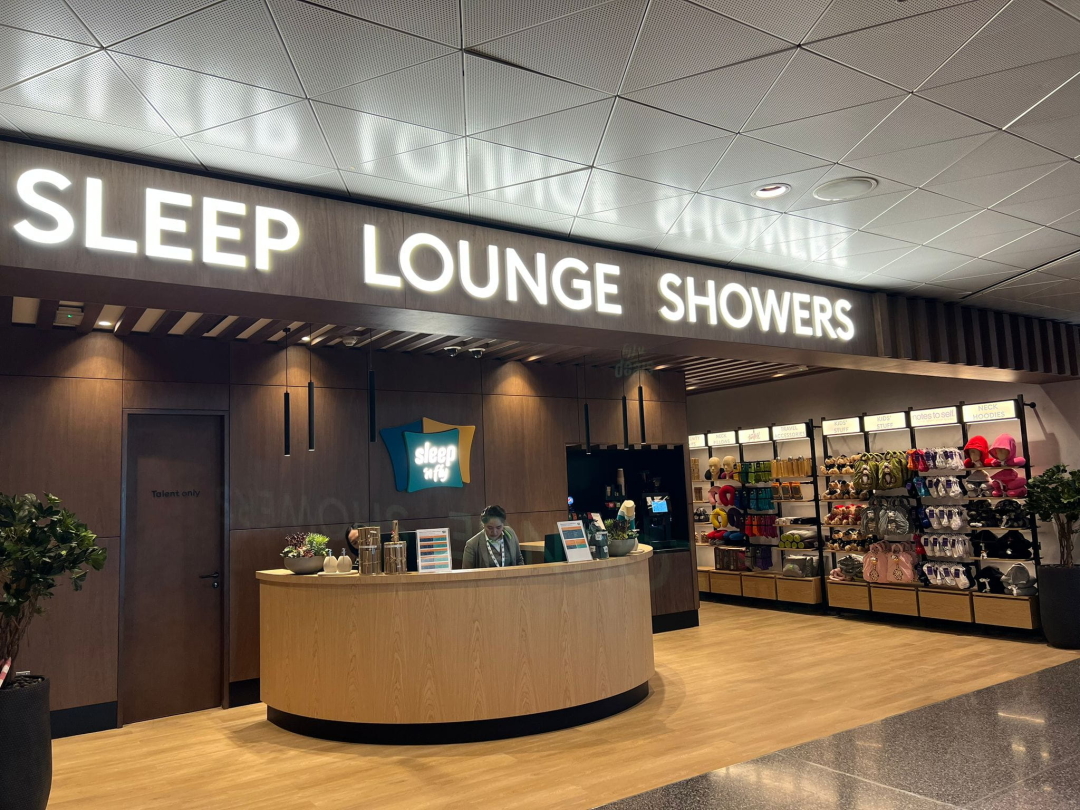 Sleep and Fly entrance at Hamad International DOH with signs for "SLEEP", "LOUNGE", "SHOWERS"