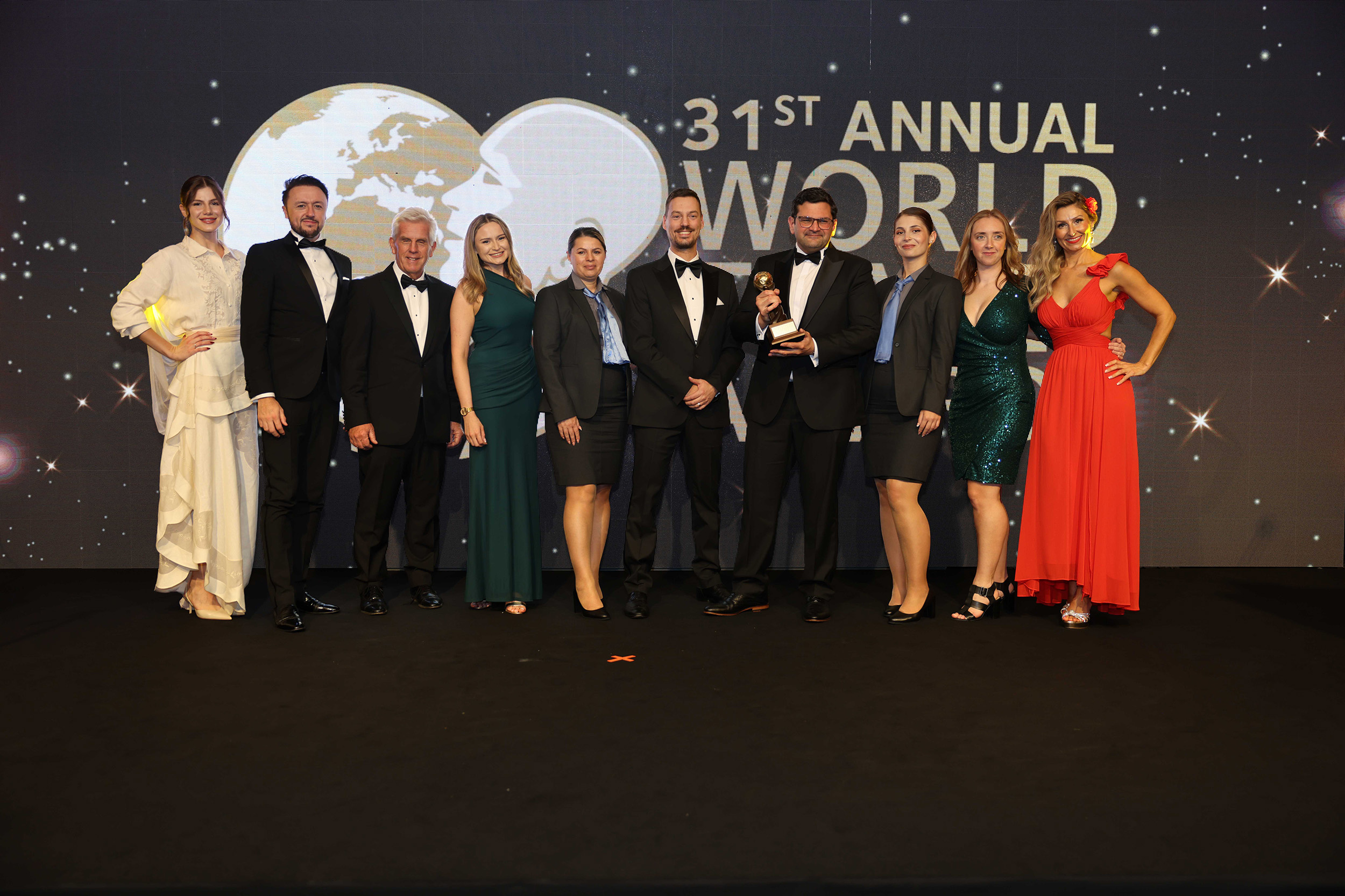 Group of men and women on stage receiving award 