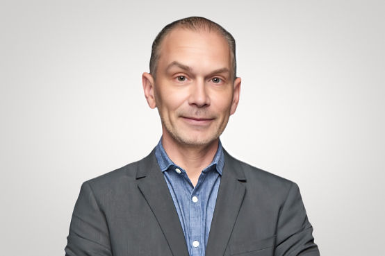 Airport Dimensions, headshot of business man, grey suit jacket with open collar