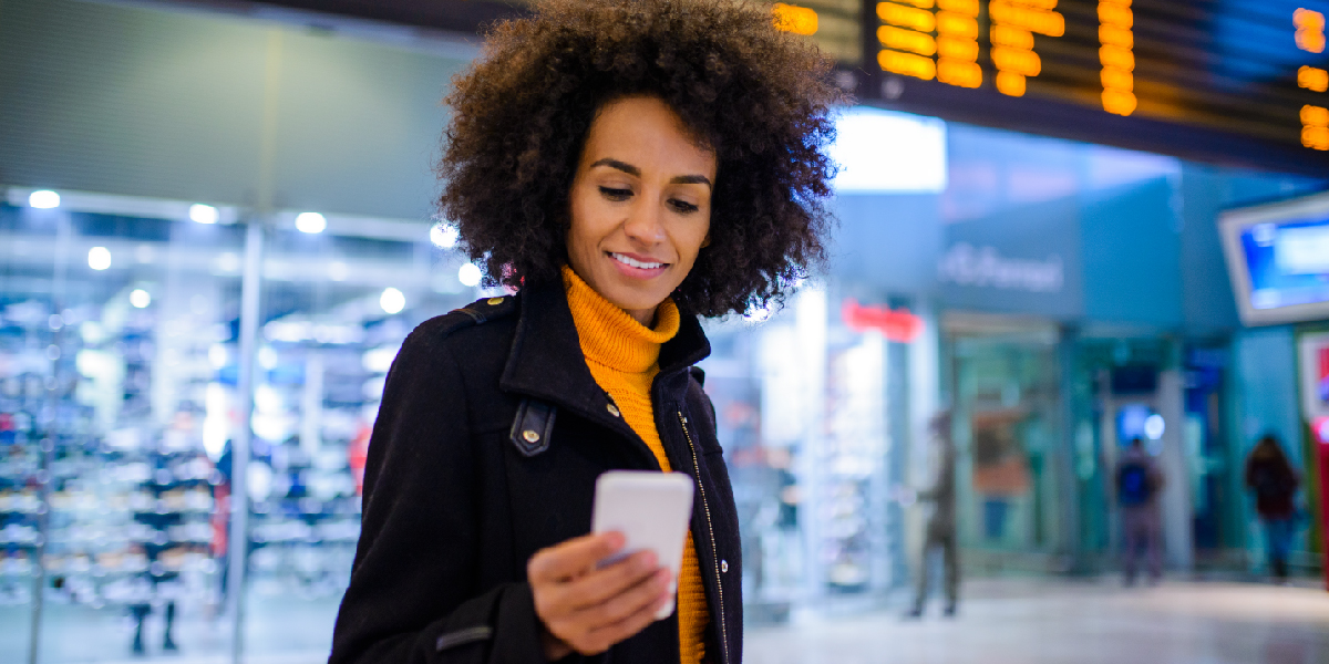 Women holding phone in airport