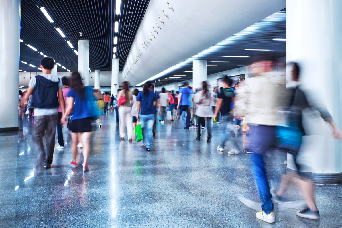 Airport concourse with travelers walking 