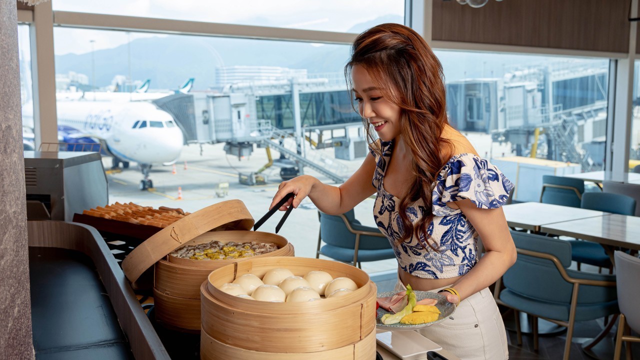 Woman dishing up food at buffet at airport lounge