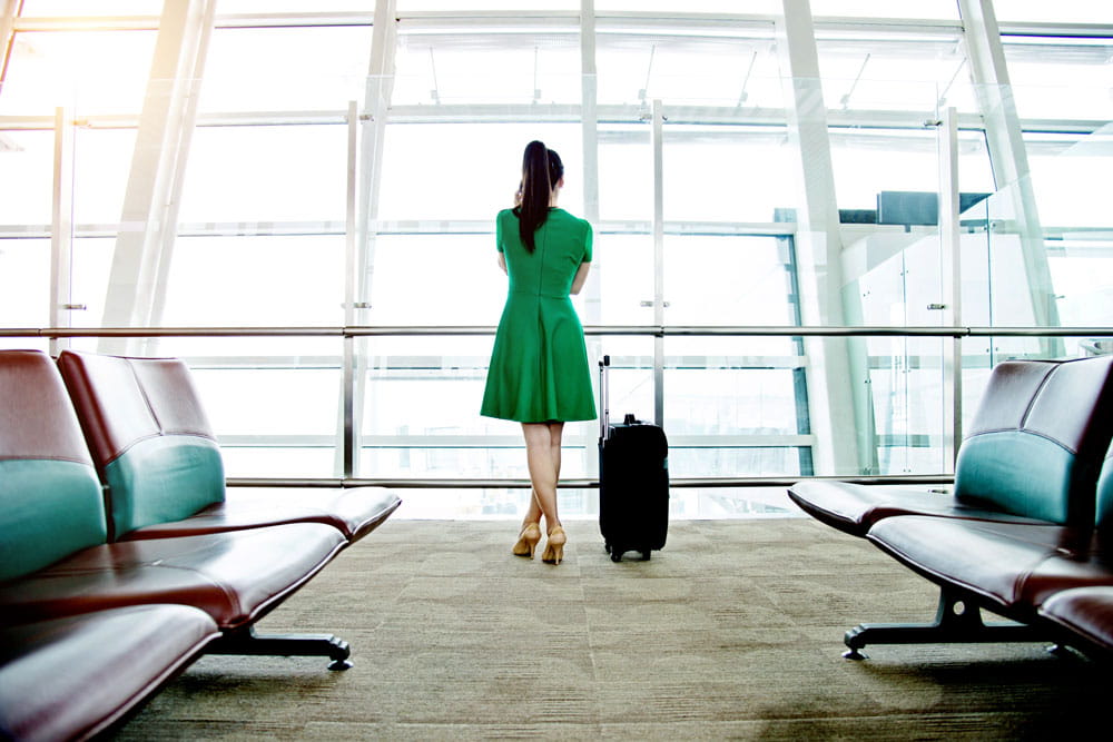 Female in green dress waiting in airport