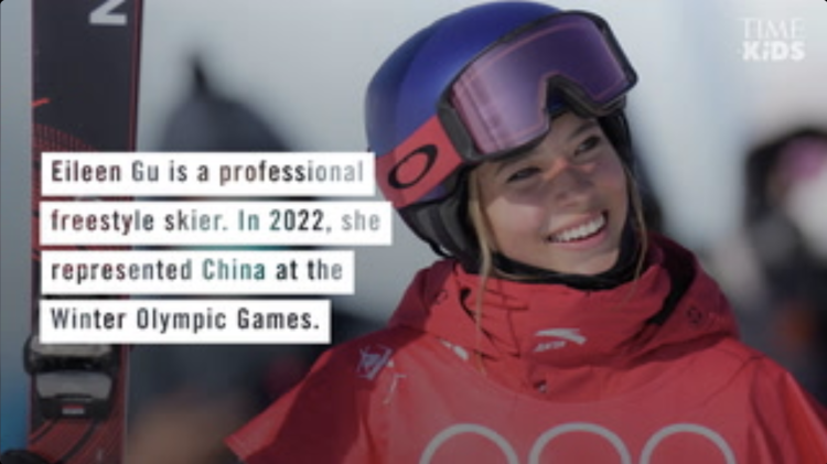 Eileen Gu, smiling and fully suited in her ski gear holding her skis in one of her hands with a text overlay that reads, "Eileen Gu is a professional freestyle skier. In 2022, she represented China at the Winter Olympic Games".