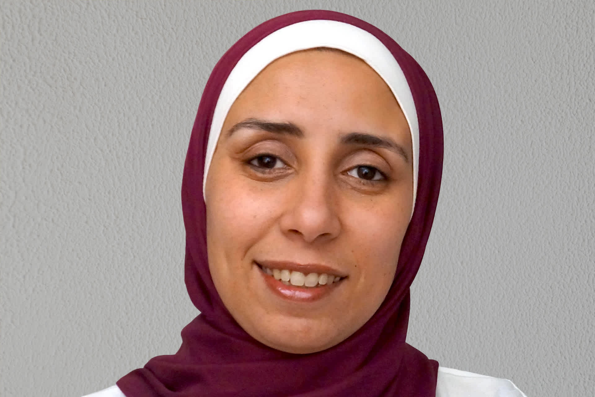 A portrait of a smiling woman.