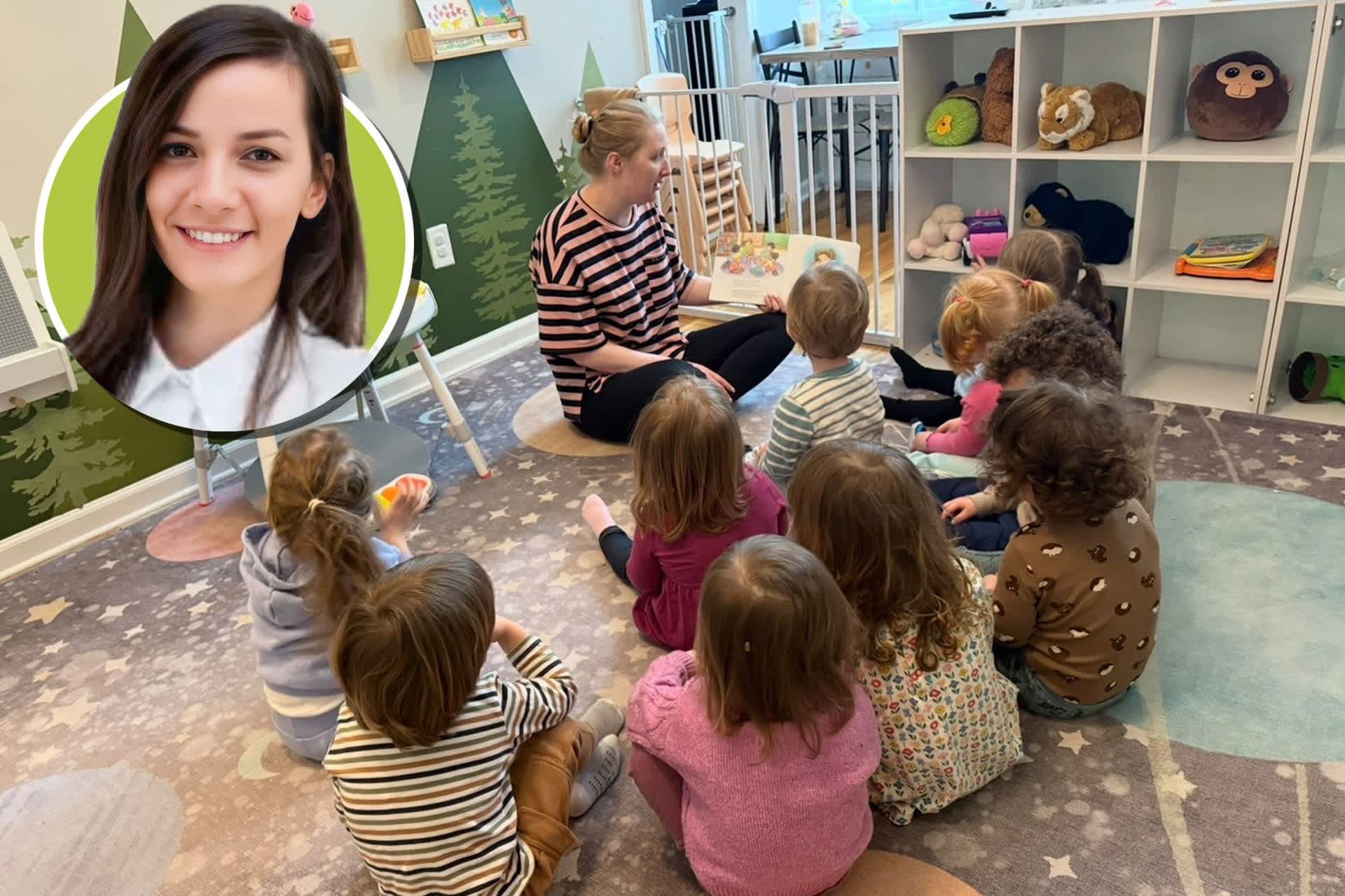 A teacher reads to a group of young children sitting on the floor in a room full of toys