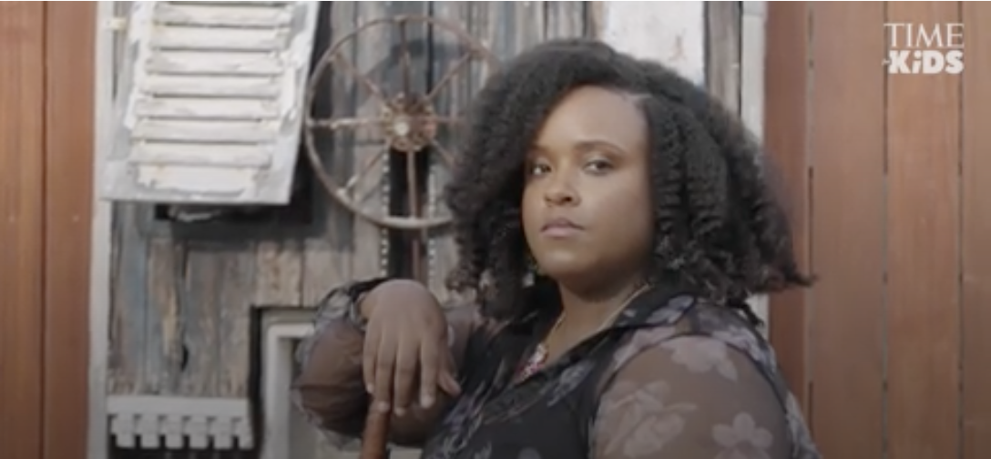 Alyssa-Amor Gibbons seated in a courtyard