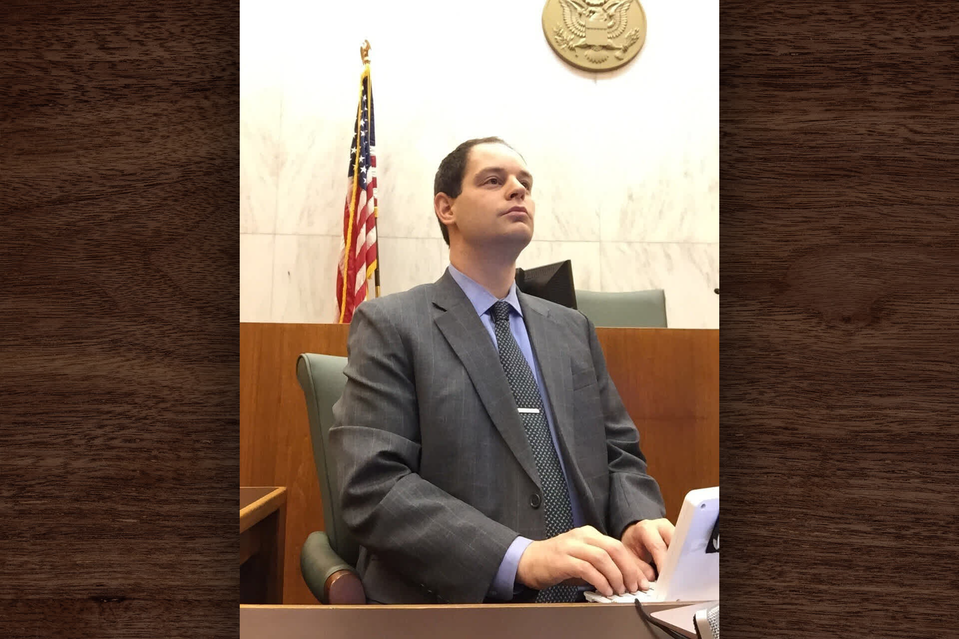 Person types on steno machine in courtroom