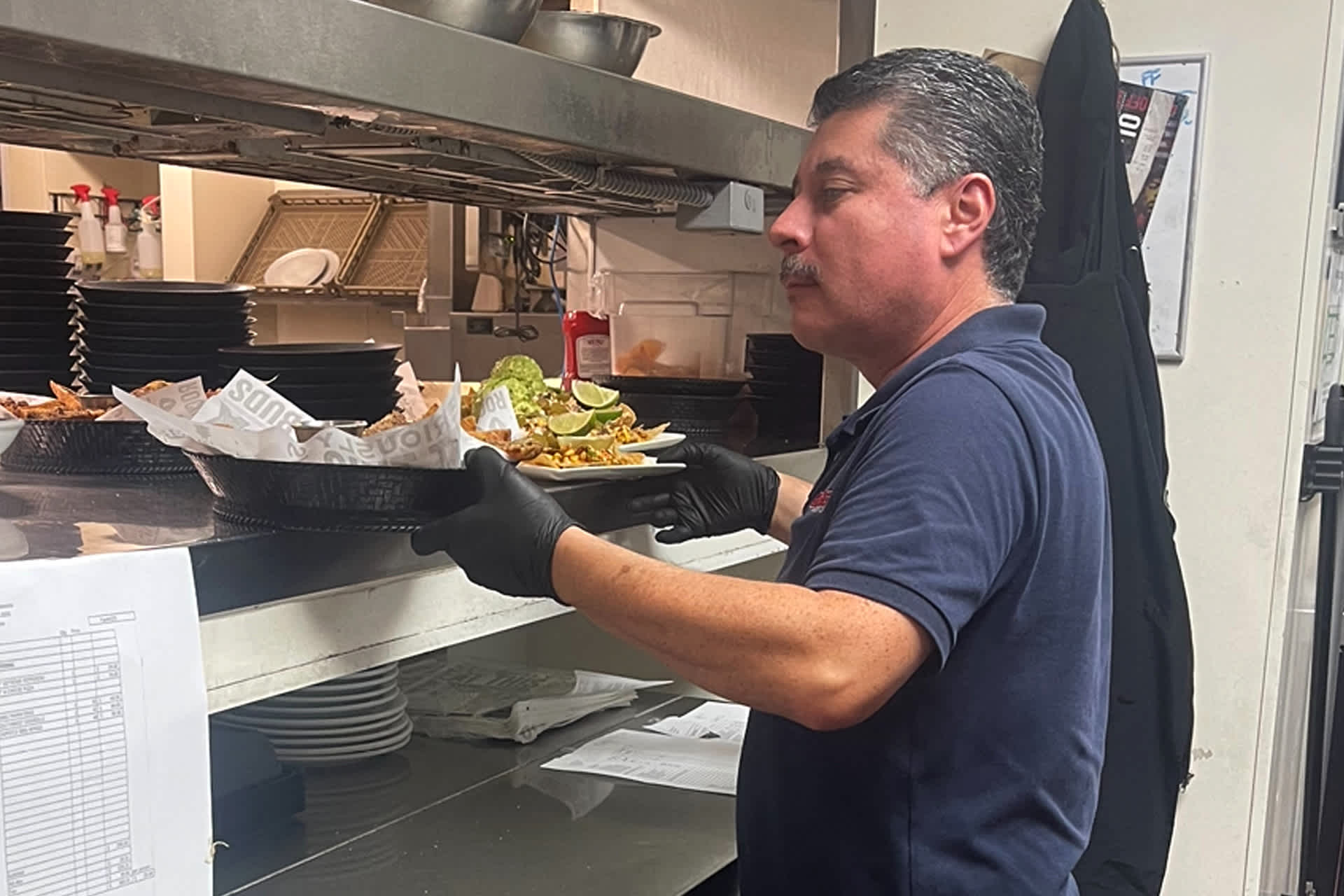 A server picks up an order from the kitchen.