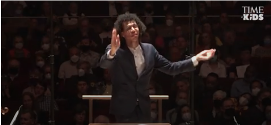 Conductor Jonathon Heyward gestures to the orchestra