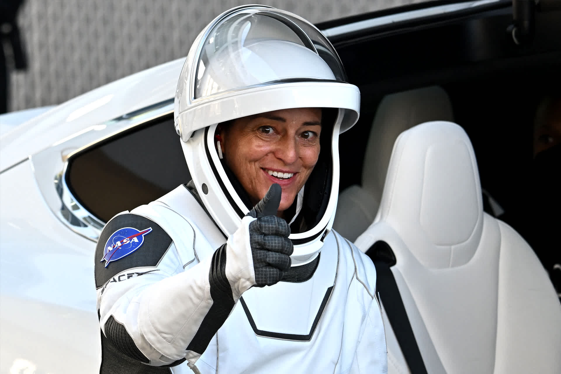 astronaut smiling and giving a thumbs-up