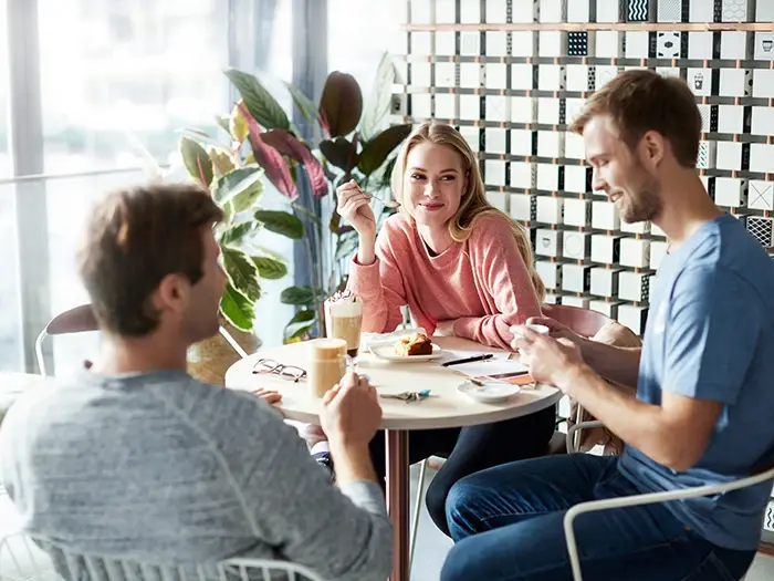 Three people in cafe or coffee corner