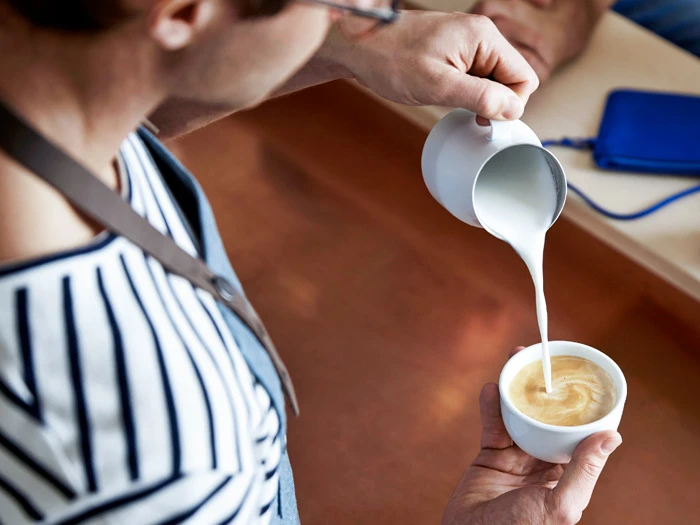 Preparing a coffee drink, latte art