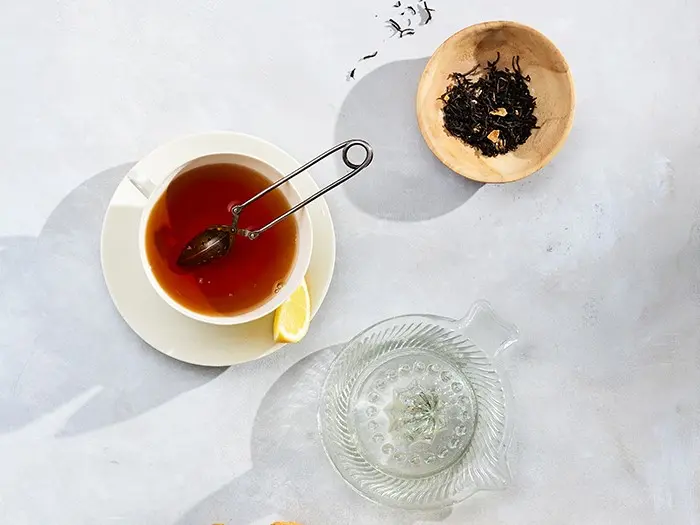Teacup, water cup and tea leaves