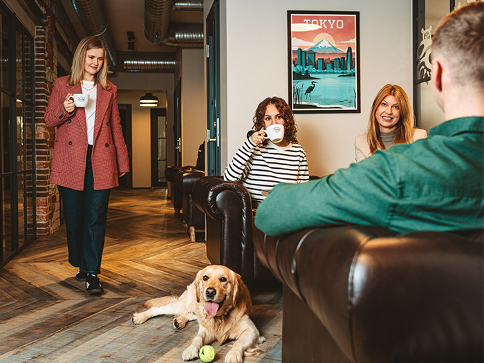 Coffee break at work with a dog visiting