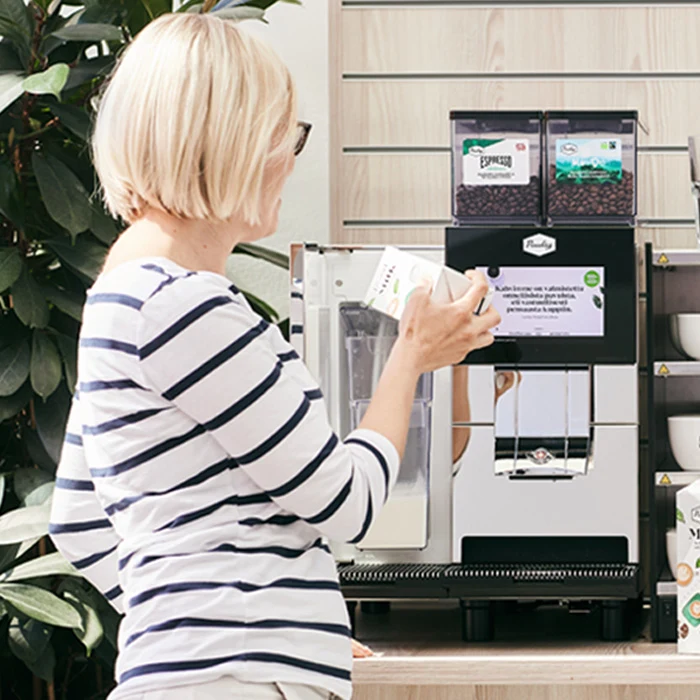 Woman standing at Thermoplan coffee station