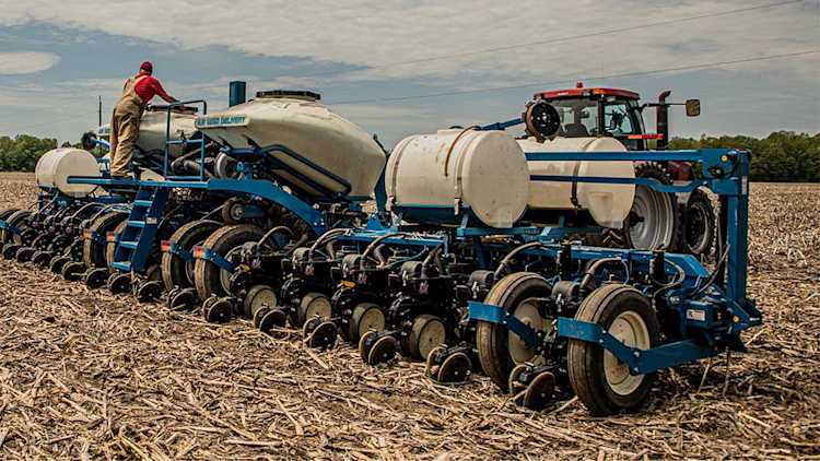 Farmer in field checking out their planter in the spring.