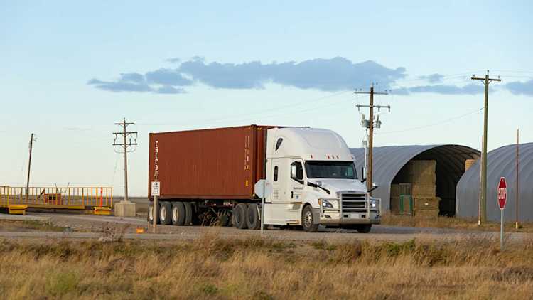 Semi-tractor trailer on road.