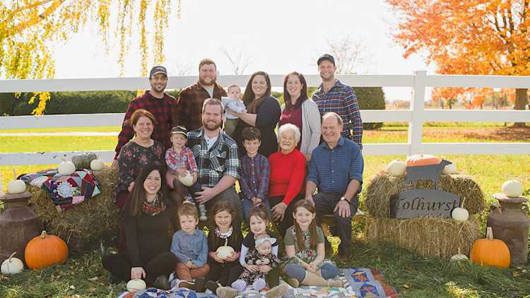 Tolhurst family members and farm employees in front of silos.