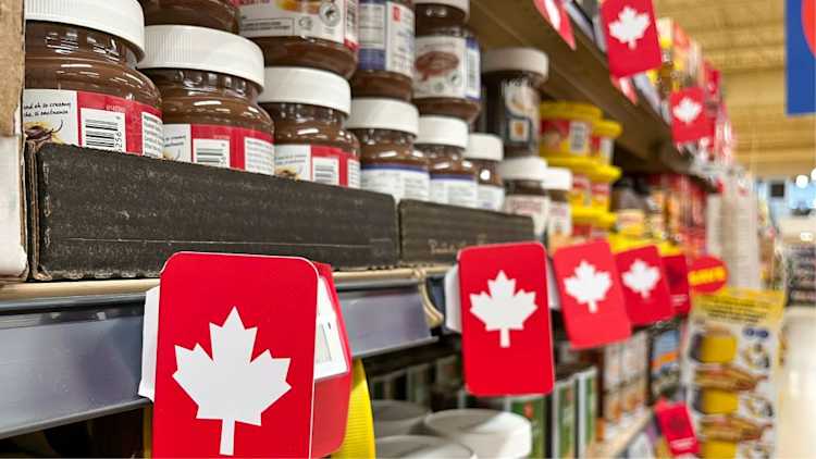 Grocery store shelf with jars of chocolate spread, with maple leaves indicating Canadian-made products.