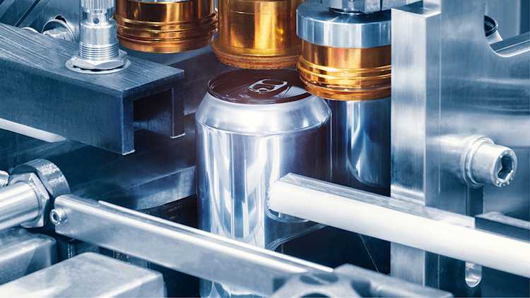 Beverage cans on production line.