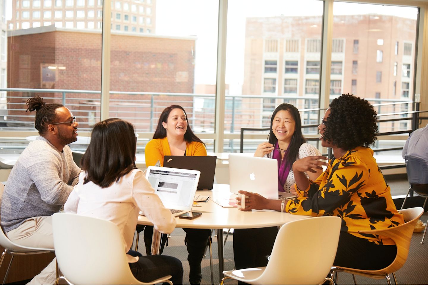Several Houghton Mifflin Harcourt employees sitting around a table.