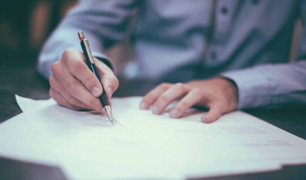 Blog - Hero - Person signing paper