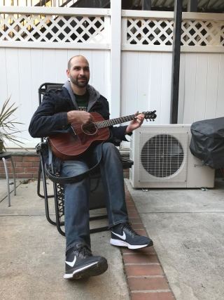 A member of the pulsedata team plays guitar at a team bonding event