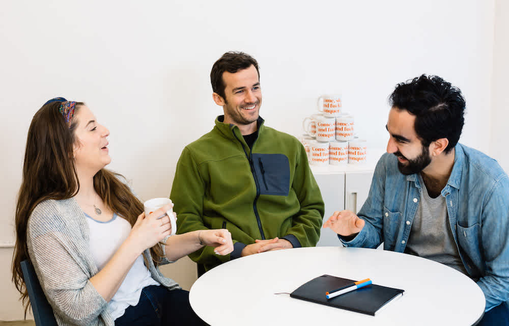 Blog - Hero - Three people laughing at a table