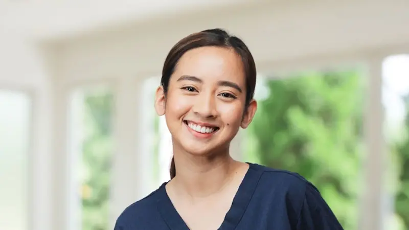 A Certified Prosthetist Orthotist in Ottobock Care branded scrubs